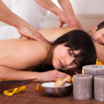 Beautiful Young Couple Enjoying Massage In Spa Centre
